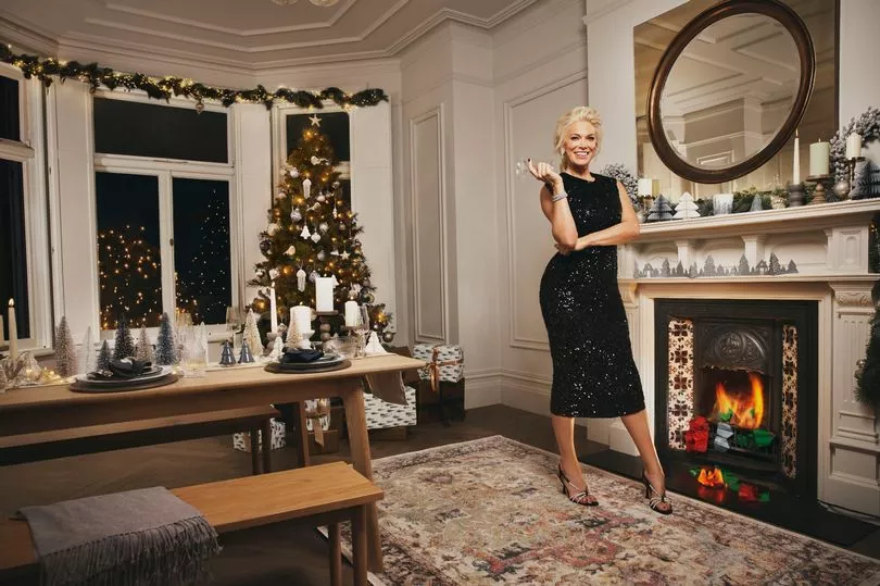 Hannah Waddingham stars in the new Marks & Spencer Christmas TV advert, standing in front of a fireplace
