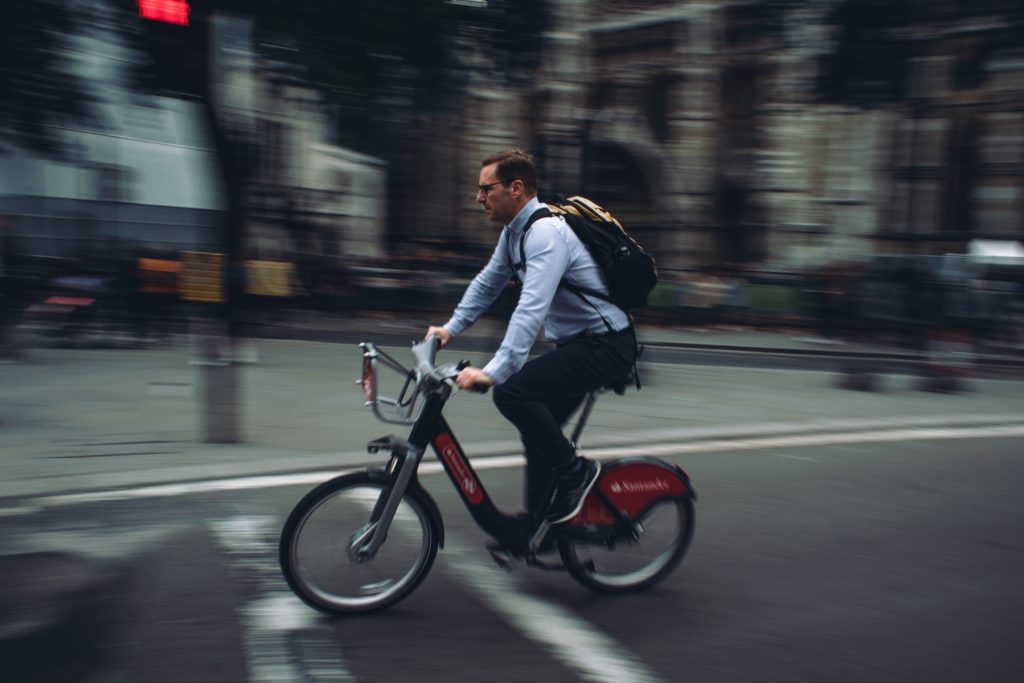 A man commutes on a rented Santander city bike in London.