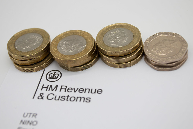 A row of coins on an HMRC letter