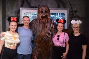 Jane and her family standing with Chewie from Star Wars