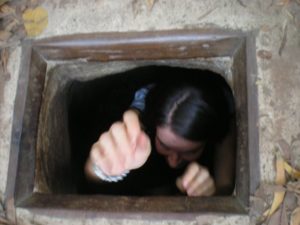 Tara climbing out of a tunnel from the Vietnam War
