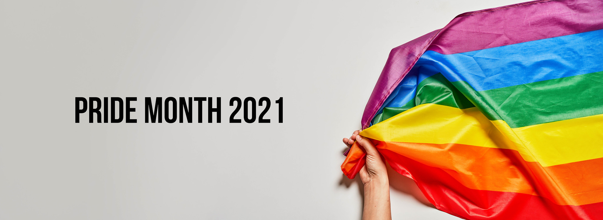 Pride Month 2021 - LBGTQ activist holds a big rainbow flag