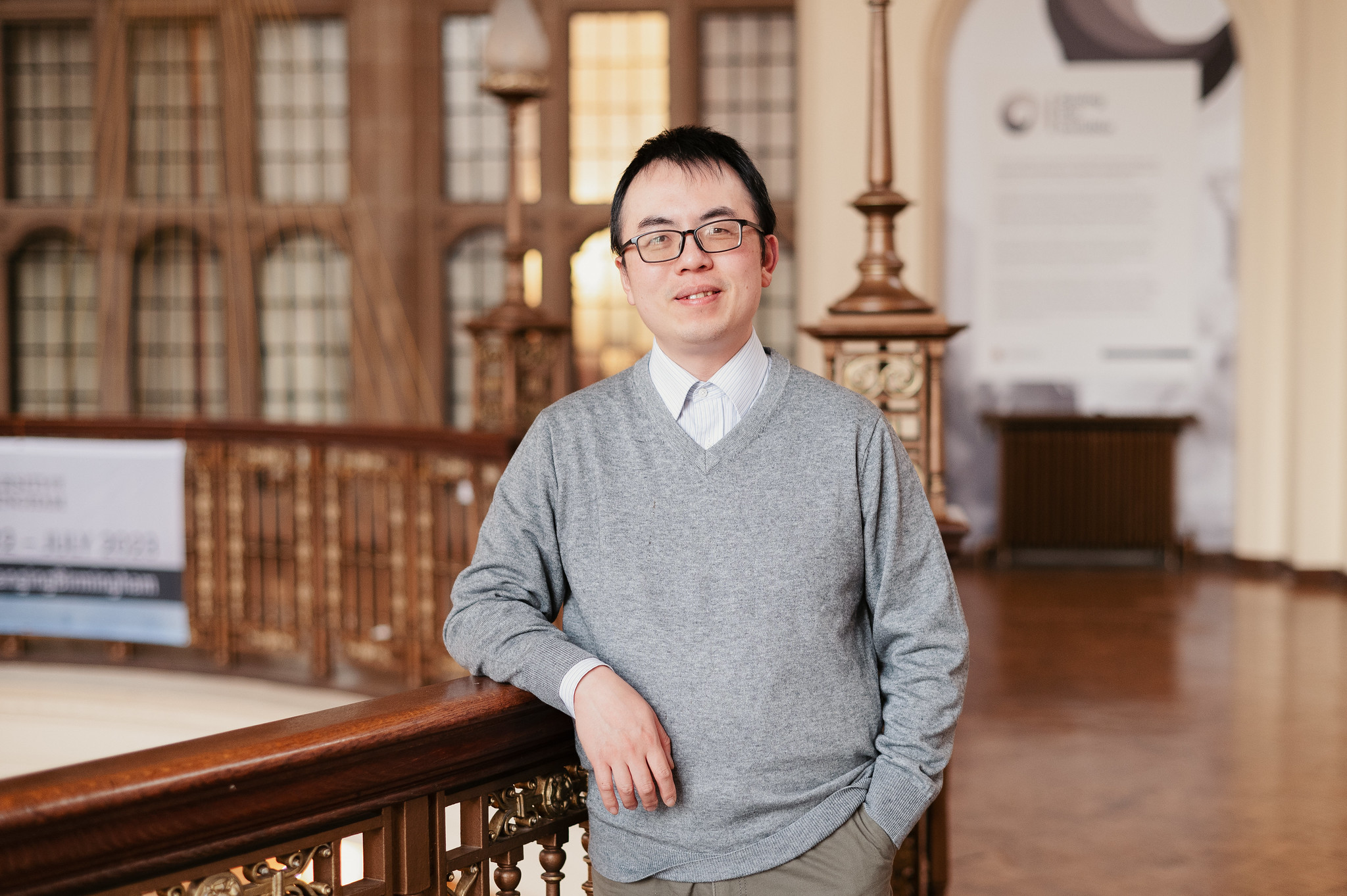 Dr Chen Zhu standing in the University of Birmingham's Great Hall rotunda