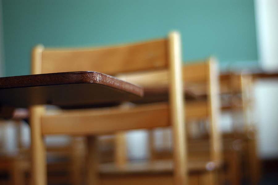 Empty chairs and desks in school