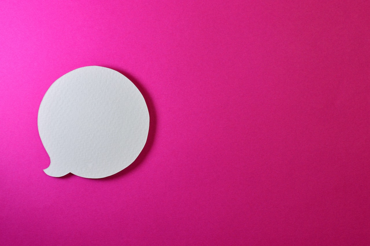 White speech bubble against a pink background