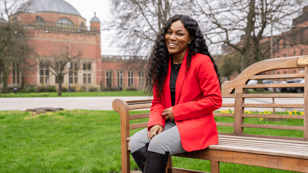 Jennifer Acheampong sits on a bench at the Edgbaston campus of the University of Birmingham