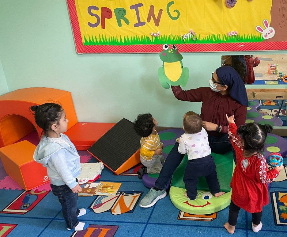 Young children learn from a teacher at a childcare setting