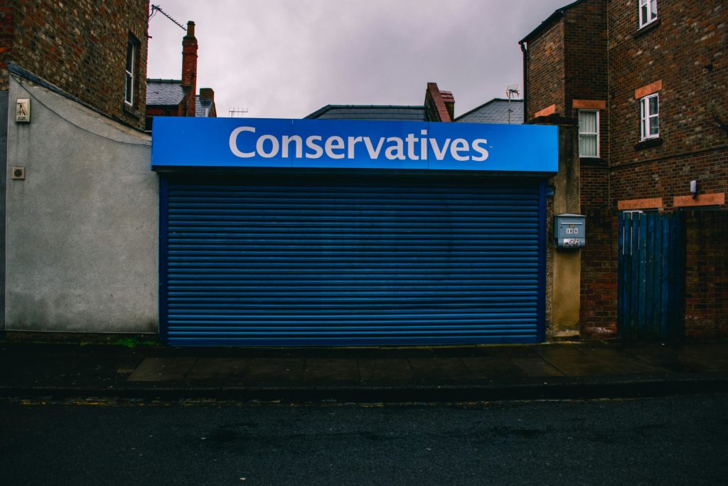 A Blue Roll Down Door with a White Signage reading "Conservatives"
