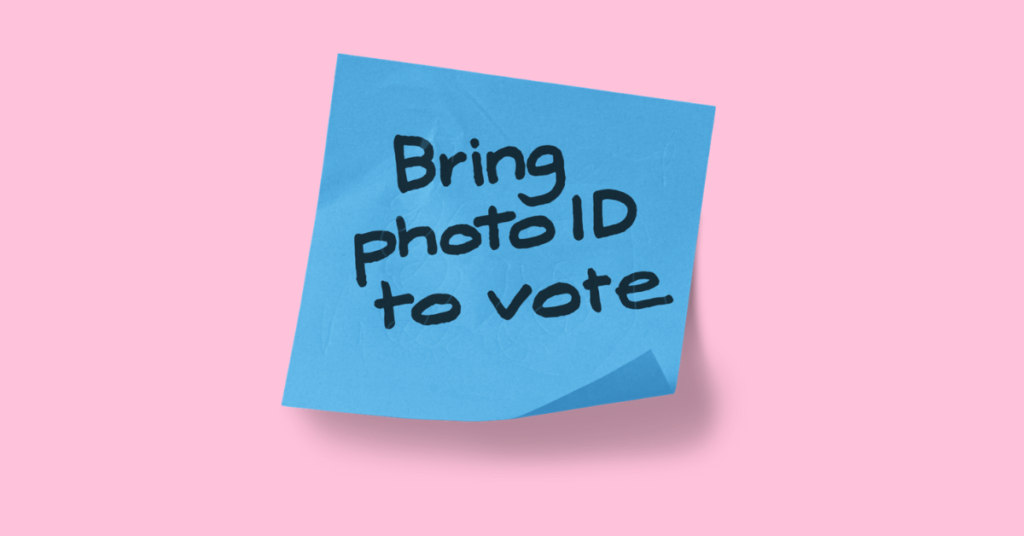 A post it note from the Electoral Commission that reads "Bring Photo ID to Vote"