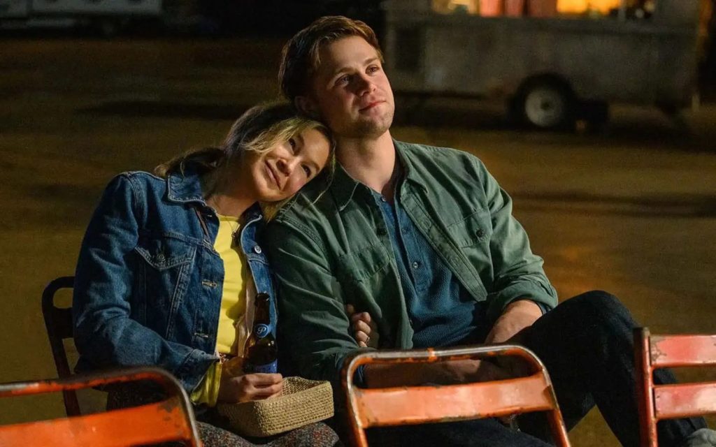 Bridget Jones rest her head on the shoulder of a man