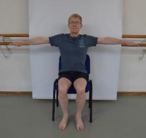 Man demonstrating sit to stand exercise with first step