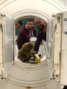 Kit and students showing Bear the Positron camera