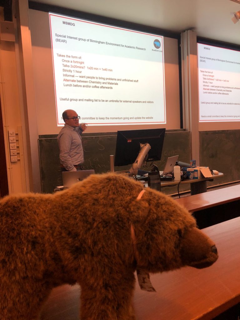 Andrew Morris explaining the Materials Simulation and Modelling Discussion Group watched by Bear