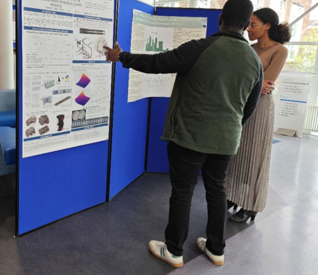 students looking and discussing a research poster