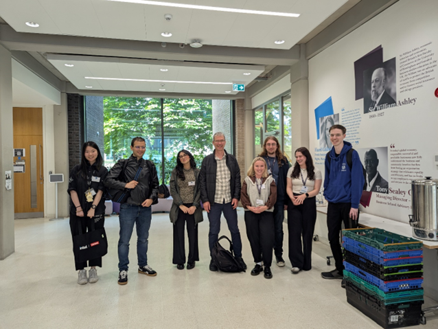 A group of people, part of the BEAR PGR organising committee, standing in a room