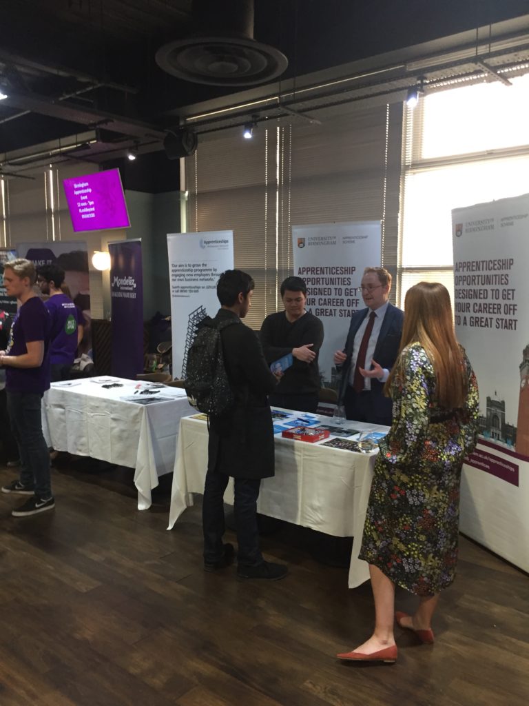 University of Birmingham marketing stand; Jared and Caleb talking to a student
