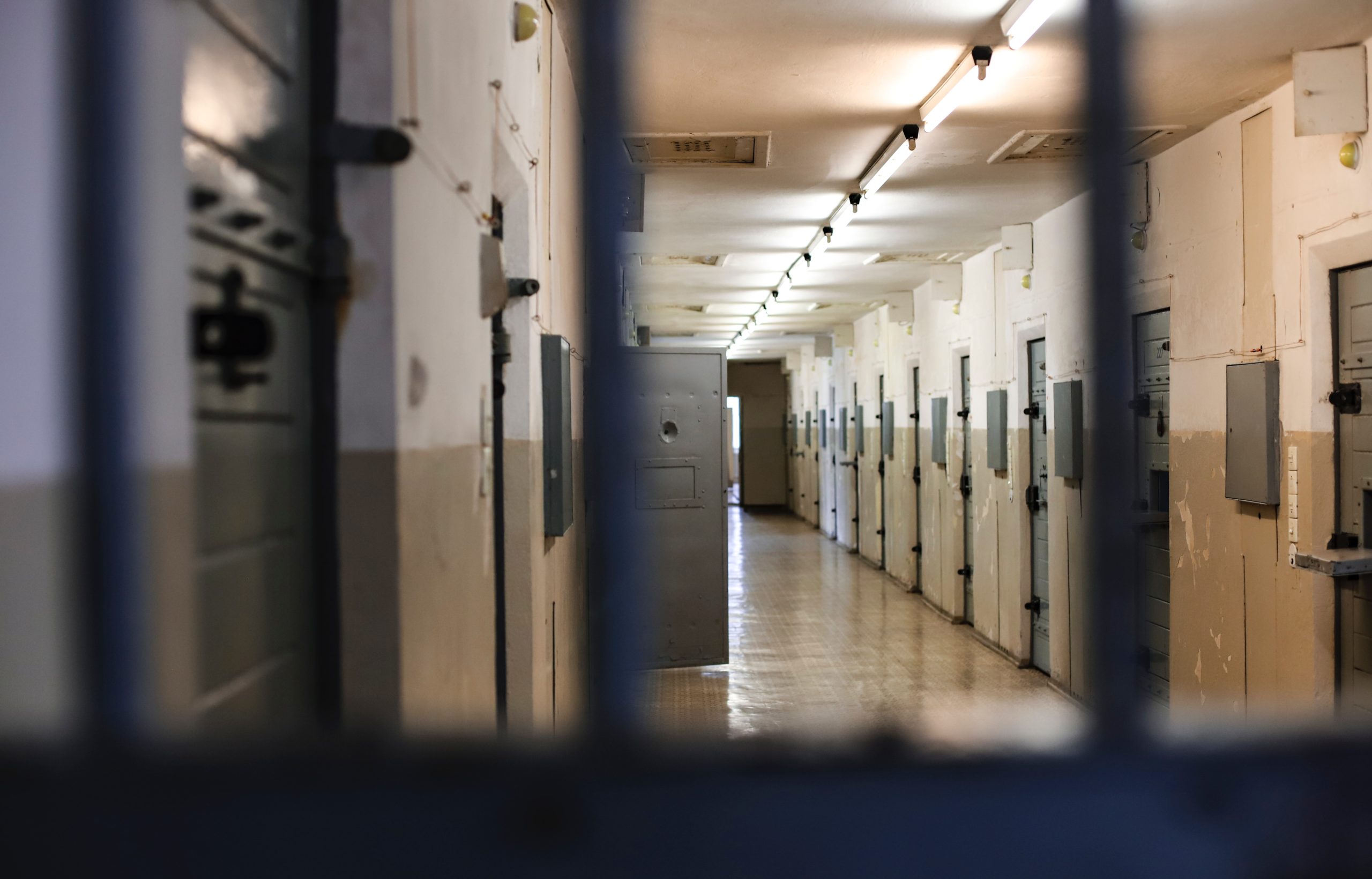 Photo of corridor in a prison with prison cells
