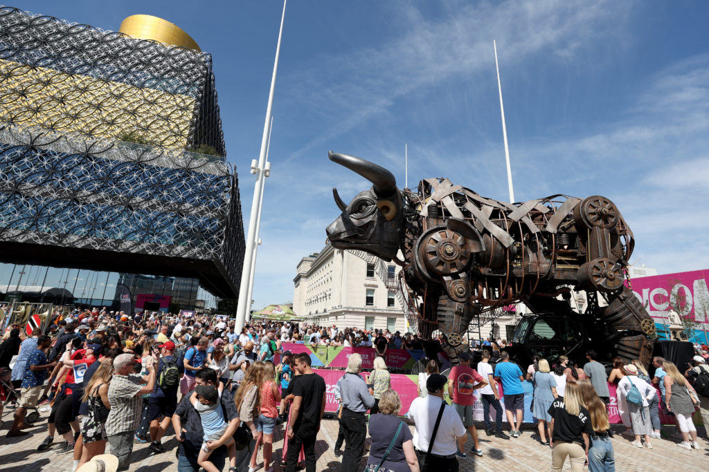 The mechanical bull from the Commonwealth Games opening ceremony in Centenary Square, Birmingham, surrounded by a crowd of onlookers.