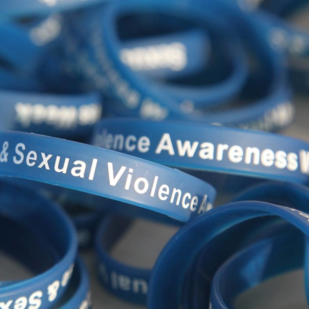 A blue bracelet with the words Sexual Abuse and Sexual Violence awareness week