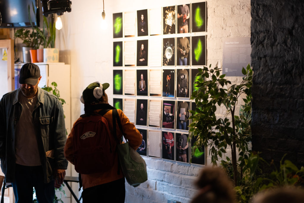 Series of photograph artworks mounted on a wall depicting people and DJ equipment